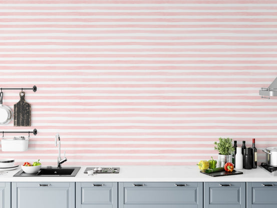 Pink horizontal stripe wallpaper in a kitchen with white cabinetry.