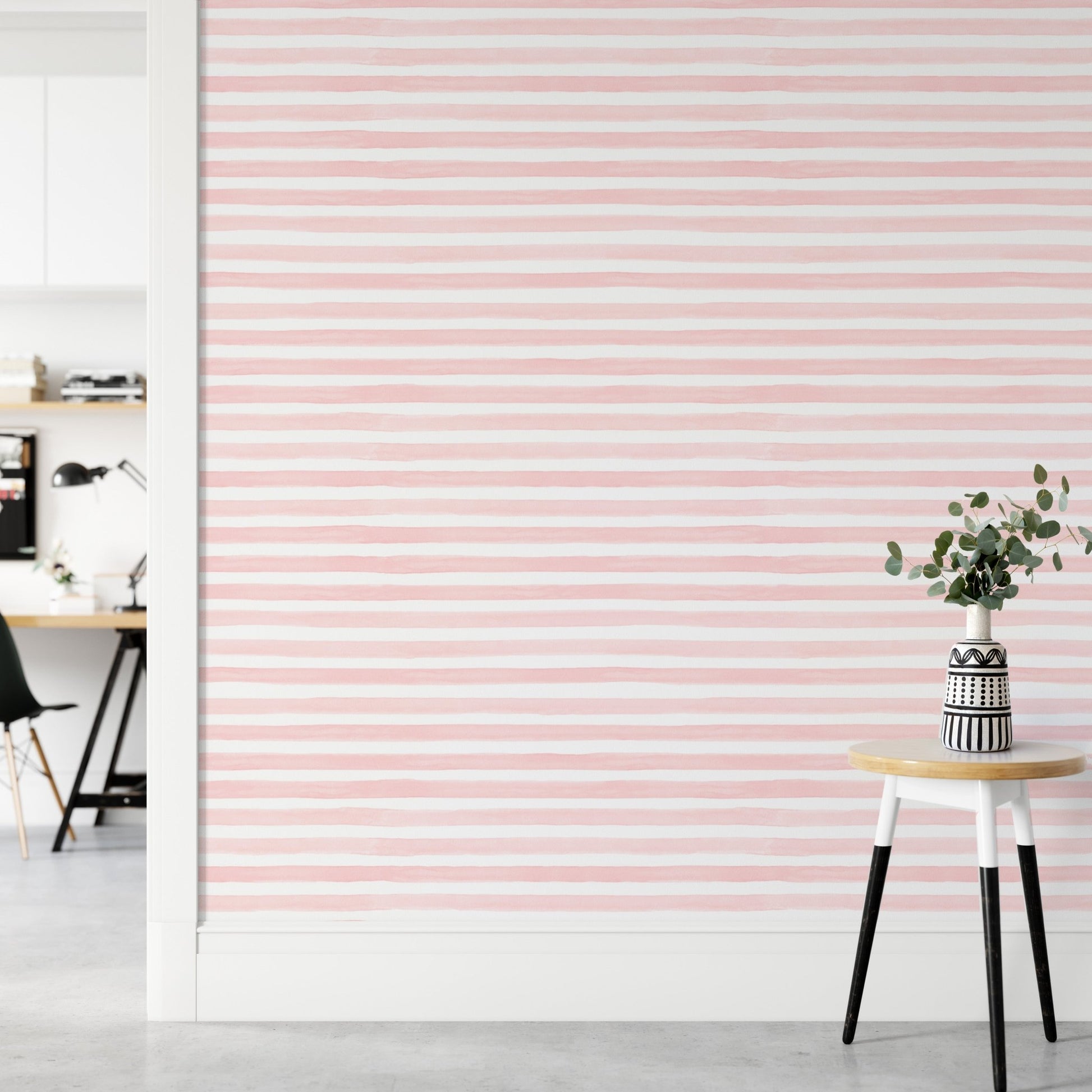 Pink Color Abstract Stripe Watercolor Wallpaper in a room with a white stool.
