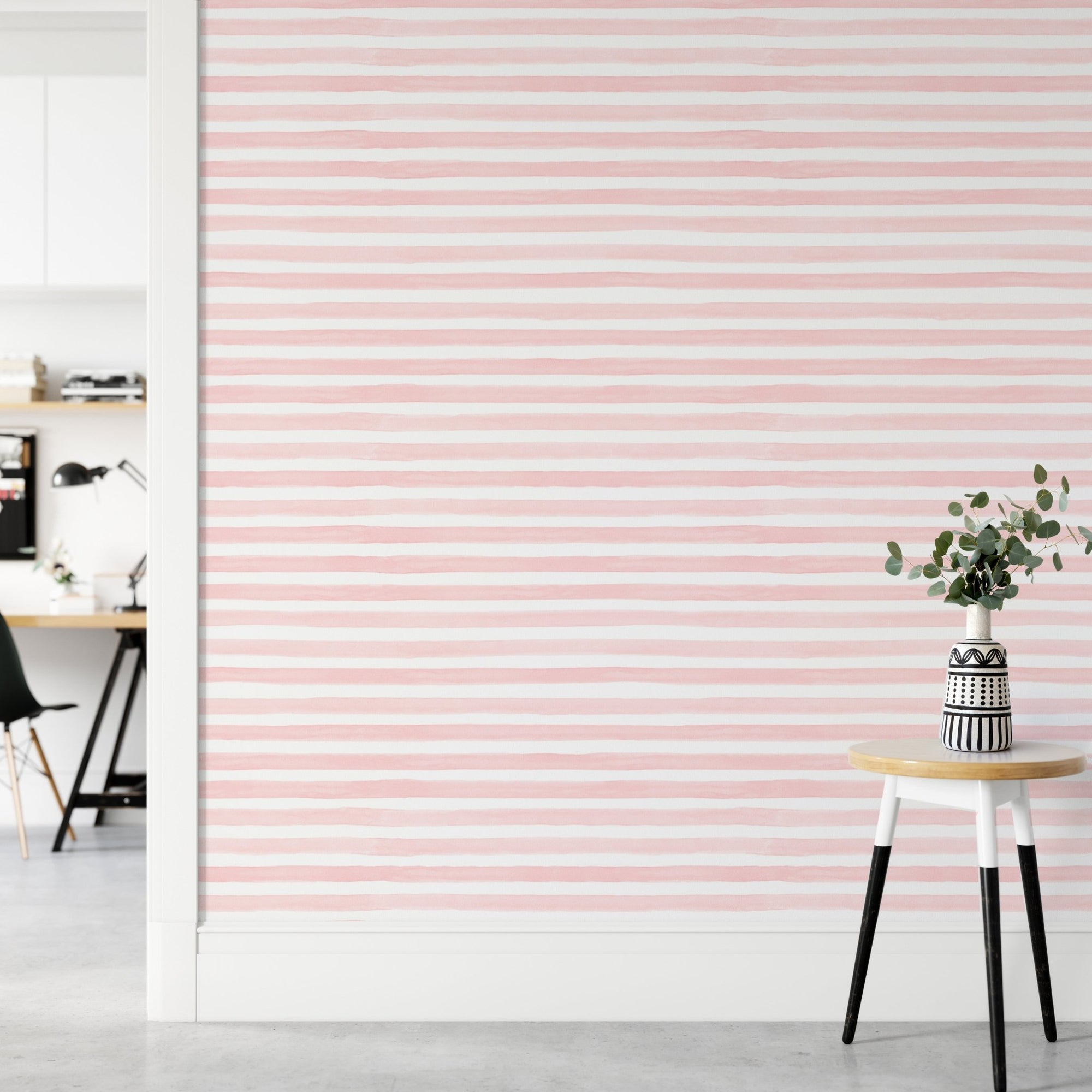 Pink Color Abstract Stripe Watercolor Wallpaper in a room with a white stool.