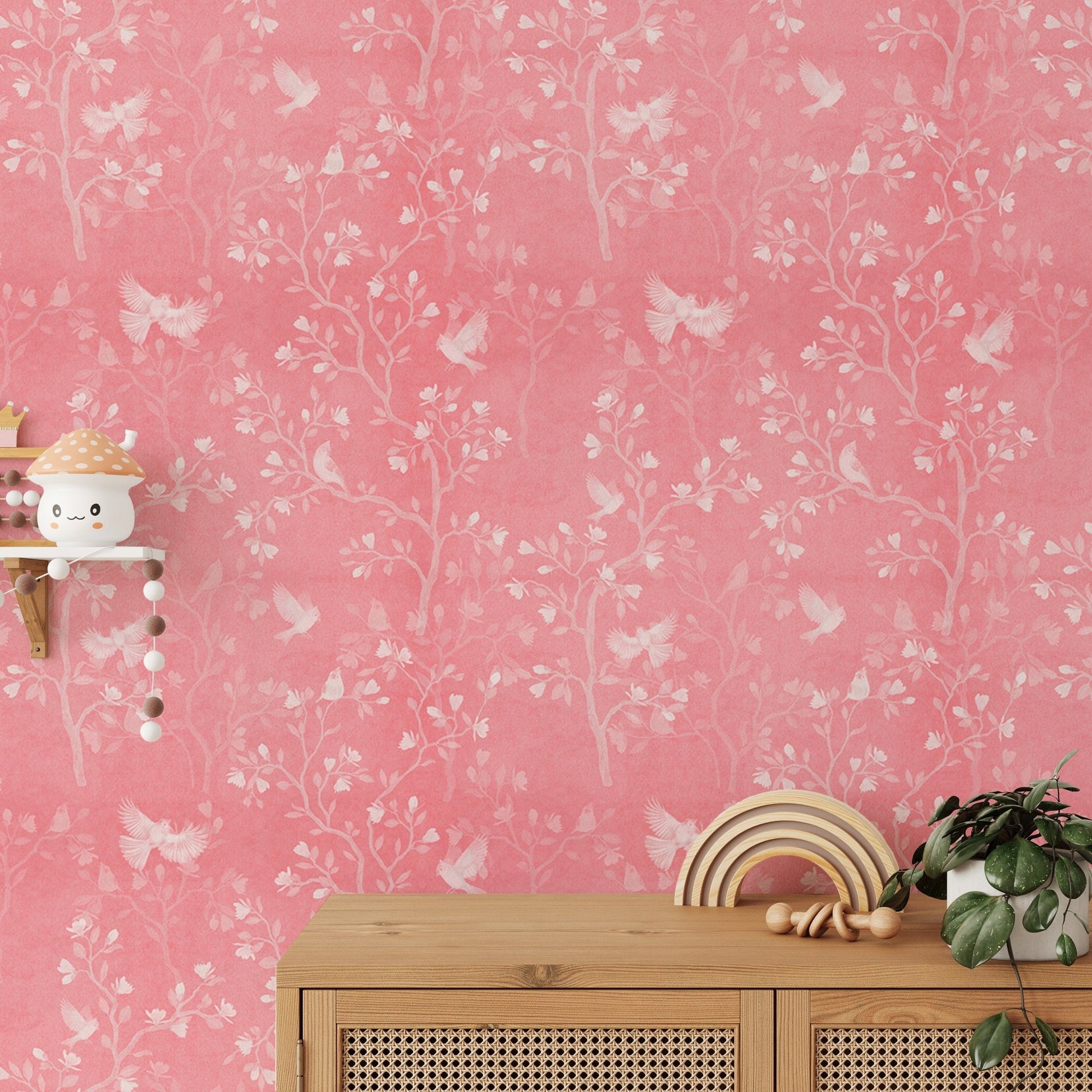 Magnolia tree and birds wallpaper behind a wooden console table with decor.
