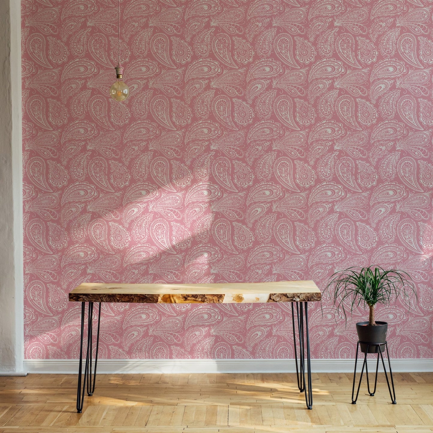Pink paisley ornament wallpaper used in a minimalist room with a wood desk.