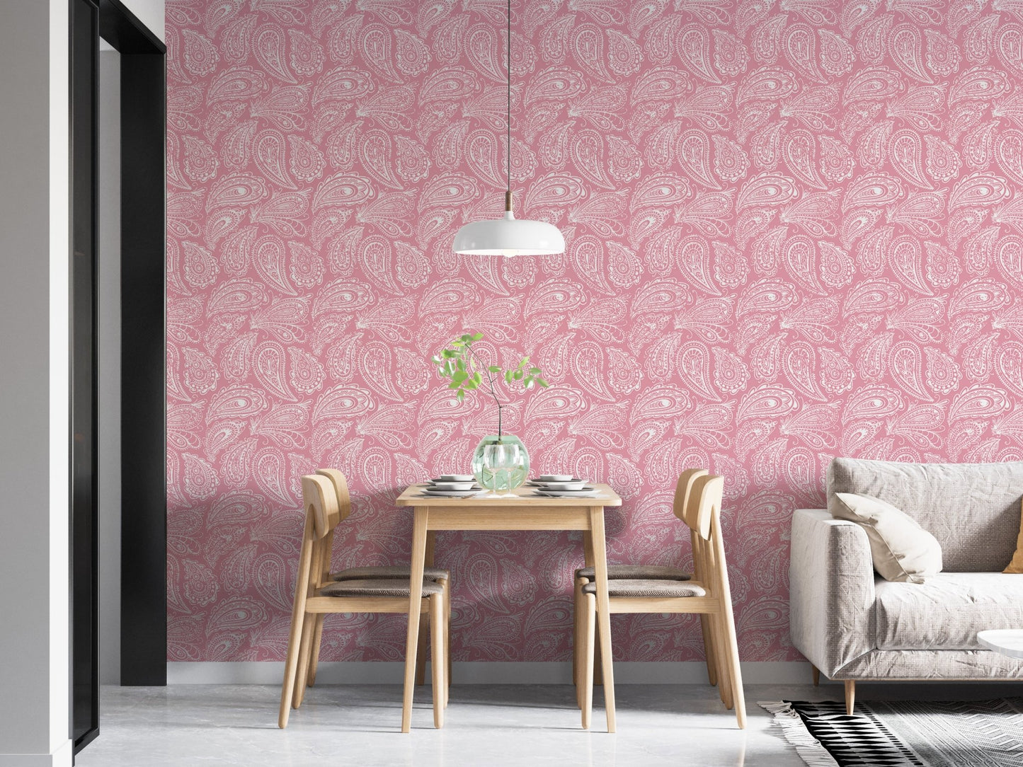 Pink hand drawn paisley wallpaper in a dining space with light wood chairs.