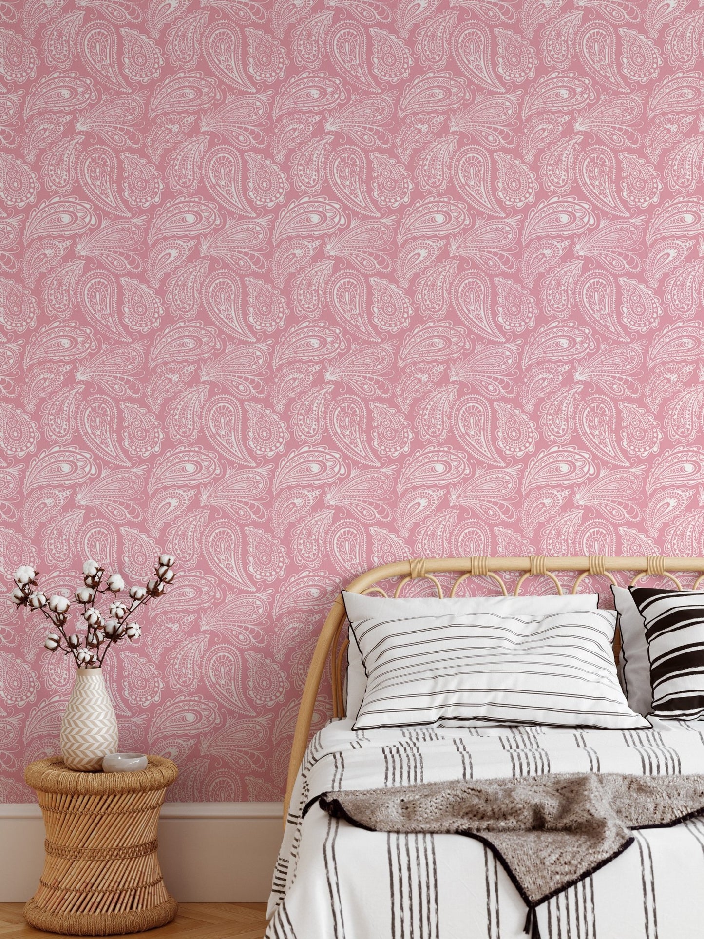 Hand drawn ornament wallpaper in a bedroom with a low wooden bed frame.