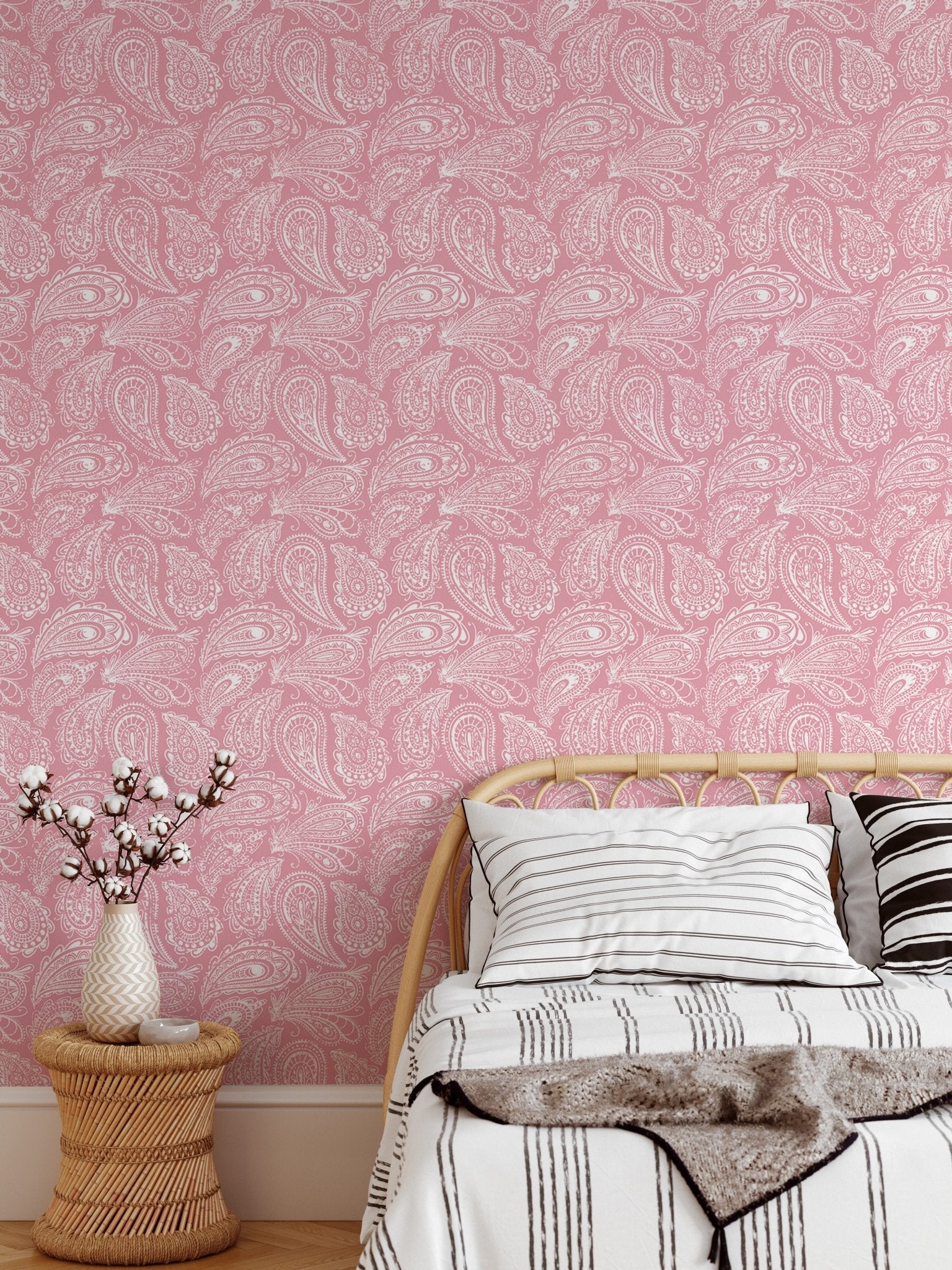 Hand drawn ornament wallpaper in a bedroom with a low wooden bed frame.