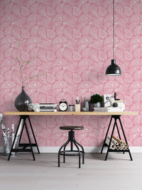 Home office setup with pink ornament wallpaper and a black metal desk.
