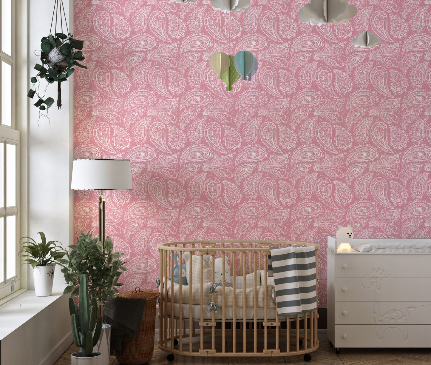 Nursery wall featuring pink hand drawn ornament wallpaper and a wood crib.
