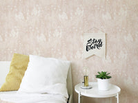 Pink Color Nostalgic Botanical Leaf Pattern Wallpaper behind a bed in bedroom.