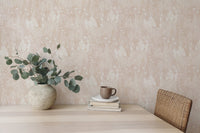 Botanical leaf wallpaper on a dining room wall behind a wooden table