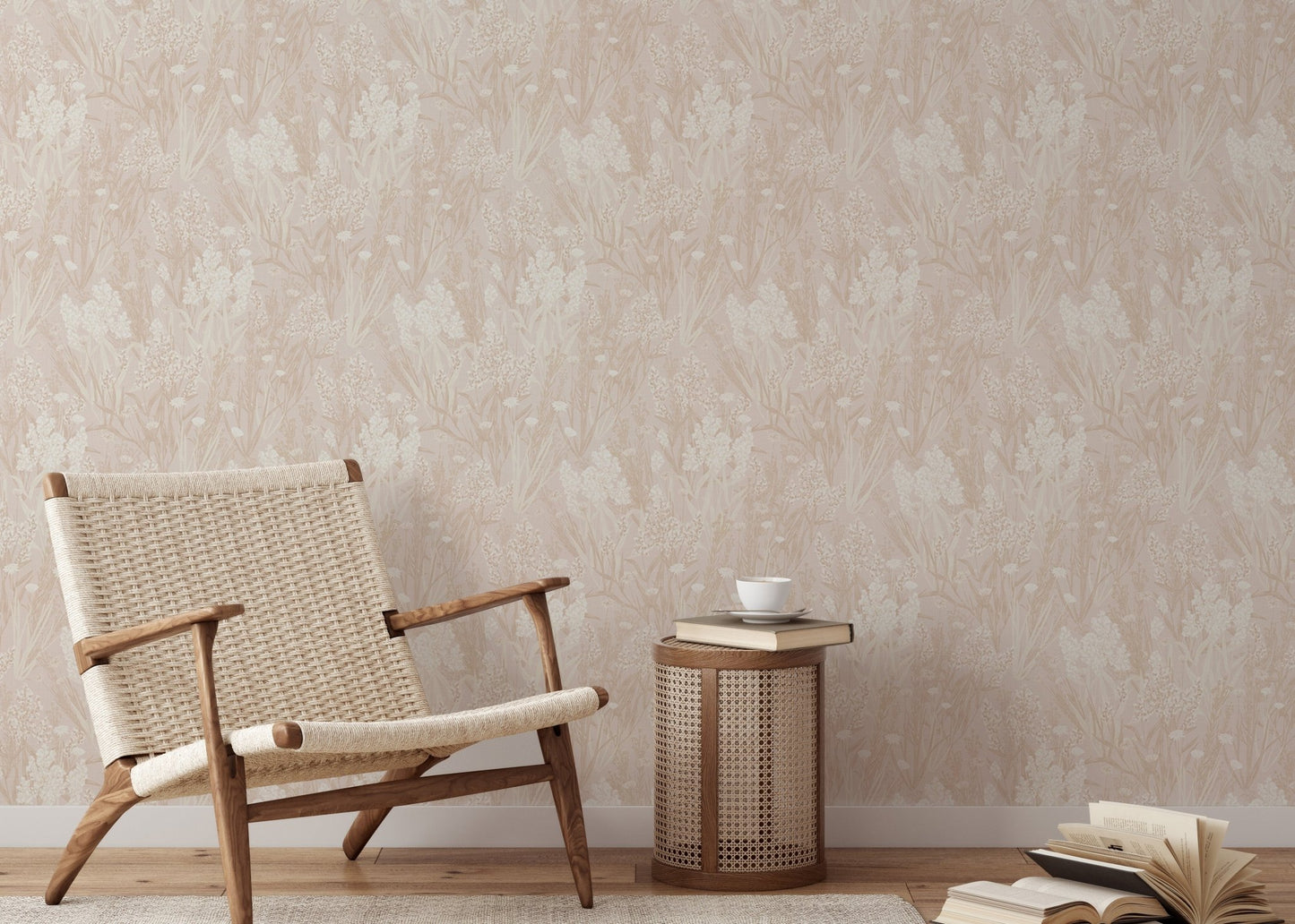 Pink wallpaper with leaf motifs in a sitting room with a woven chair
