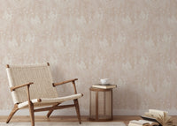 Pink wallpaper with leaf motifs in a sitting room with a woven chair