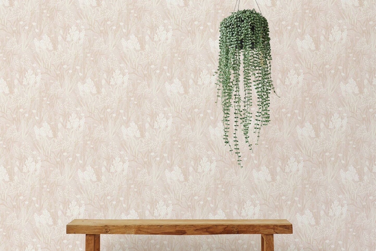 Pink nostalgic wallpaper hanging behind a wooden bench with plants