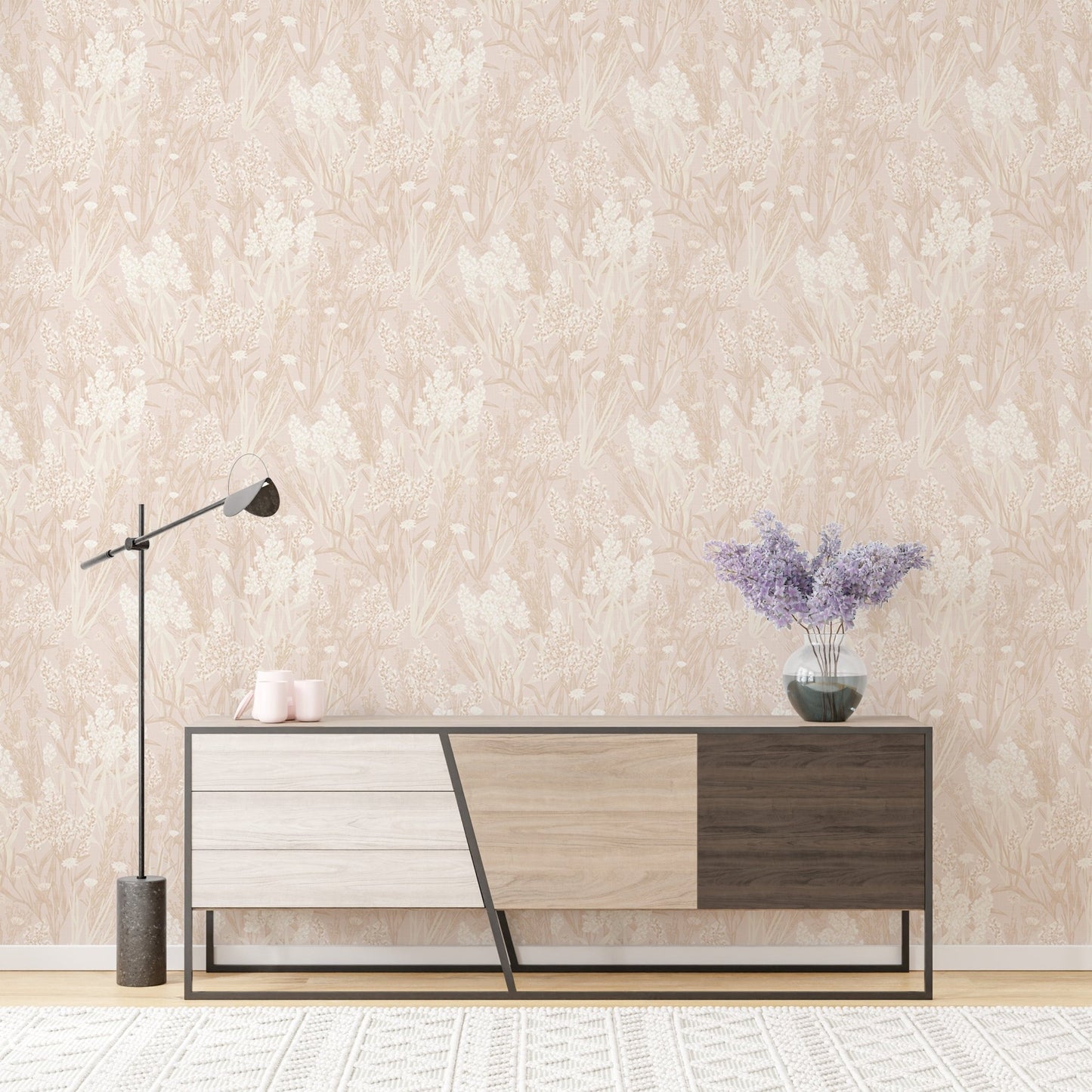Botanical leaf pattern wallpaper behind a modern sideboard and lamp