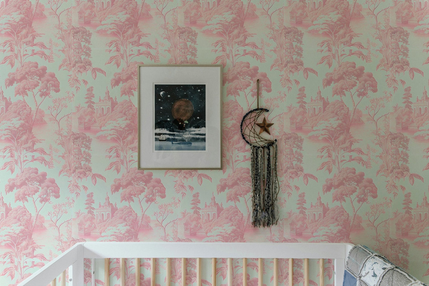 Toile tropical wallpaper in nursery room above white crib