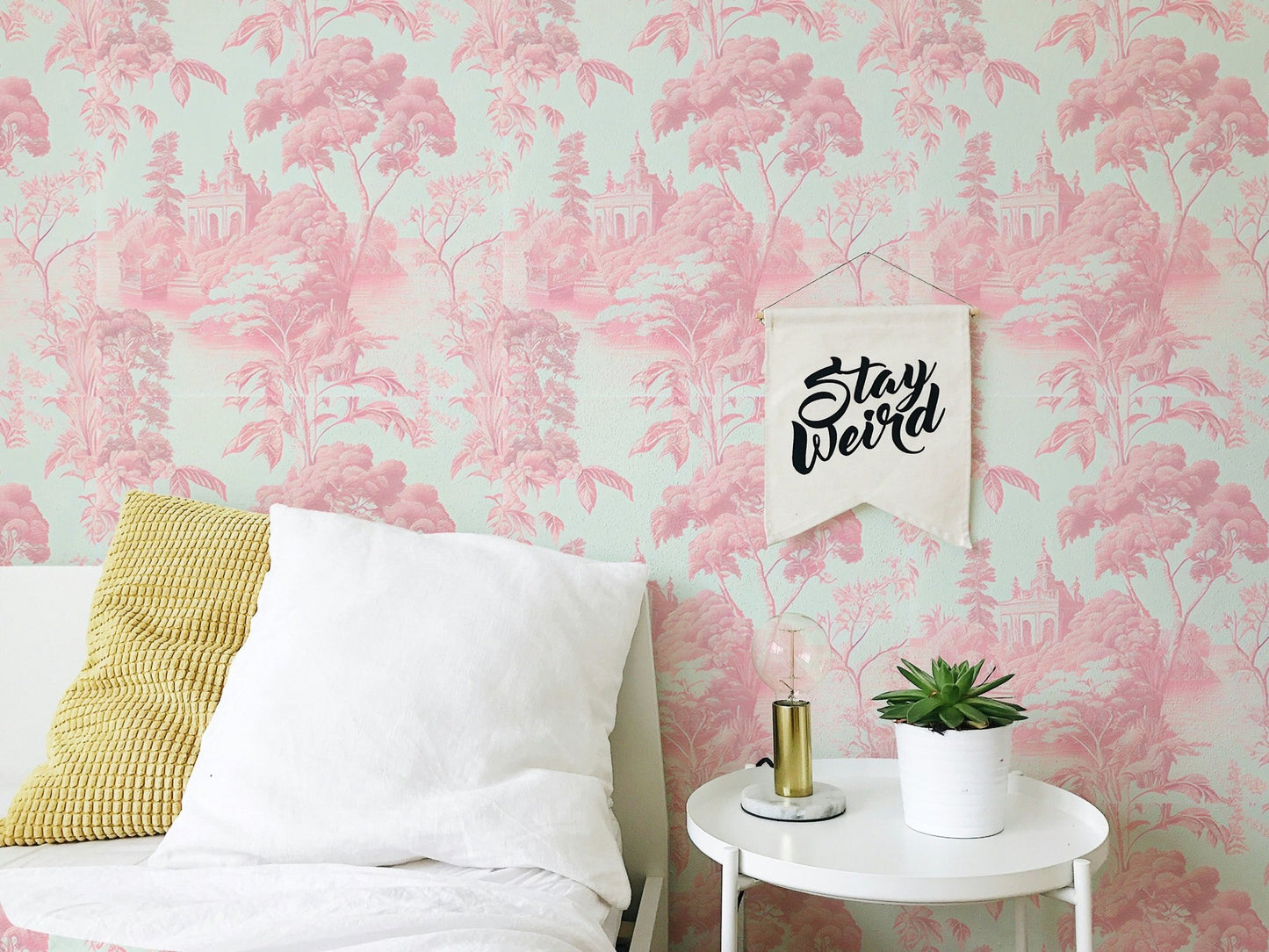 Pink toile wallpaper in guest bedroom with white pillows