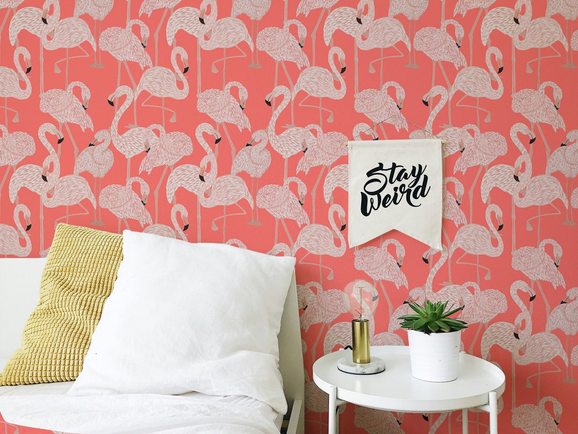 Pink Flamingos Design Peel and Stick Wallpaper on a bedroom wall with white pillows.