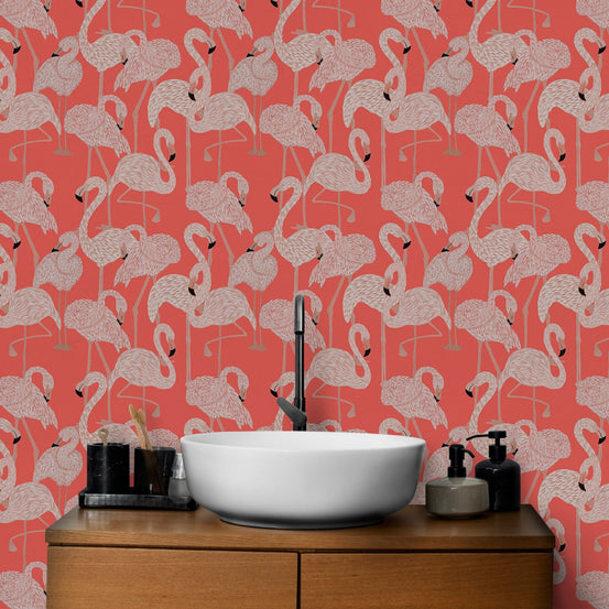 Modern flamingo wallpaper behind a bathroom vanity with a white vessel sink.