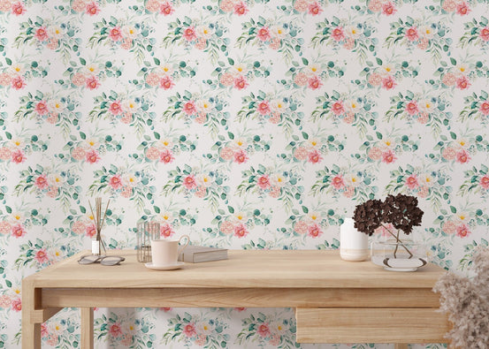 Pink floral wallpaper behind a wooden desk with a white vase.