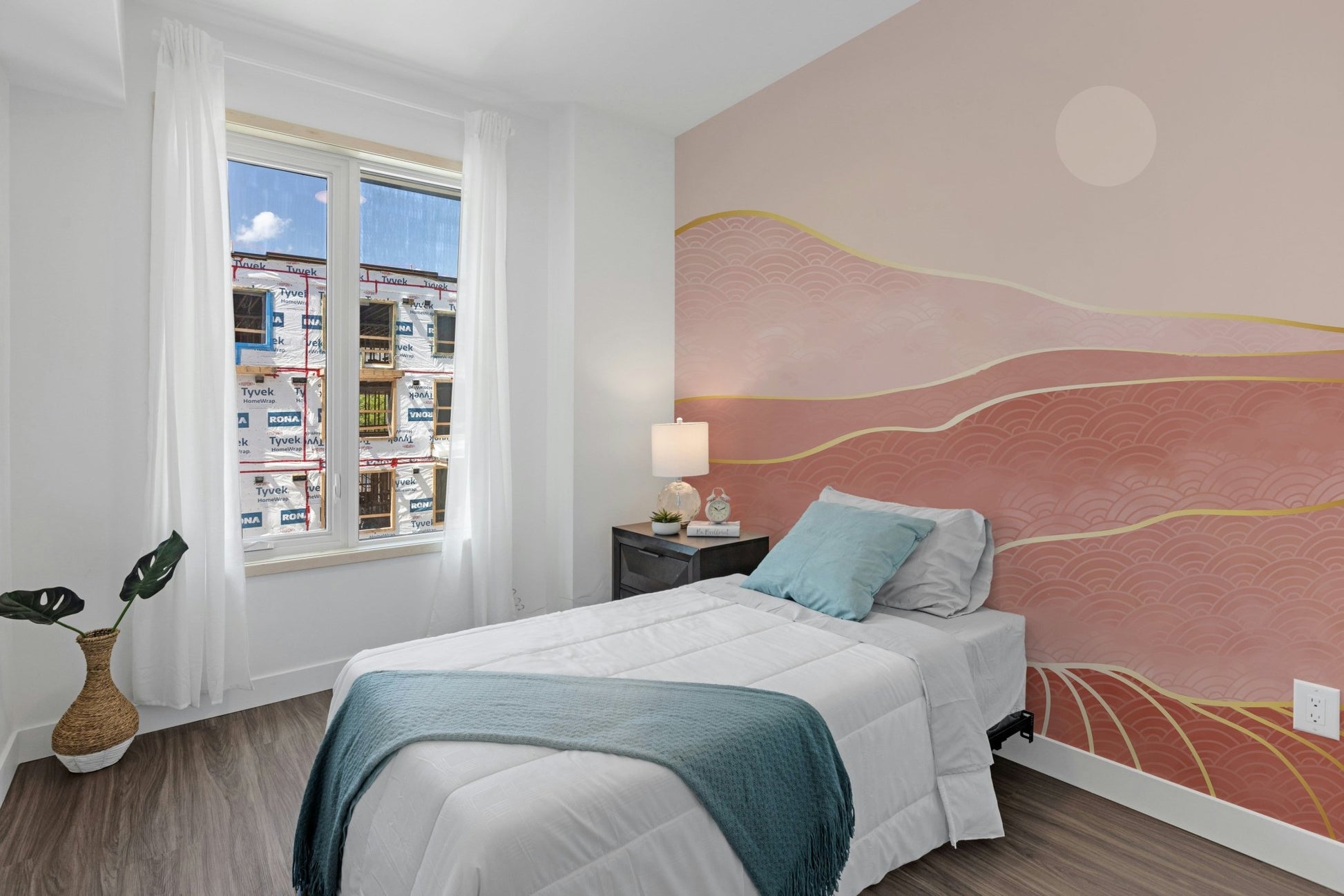 Minimalist guest room featuring pink mountain wall mural.