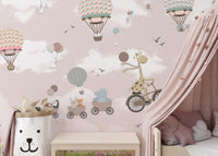 Kids room wall mural featuring a giraffe on a bicycle and pink balloons near a canopy bed.