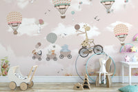 Pink Hot Air Balloon Animals Bicycle Wall Mural in a play area with a toy stroller.