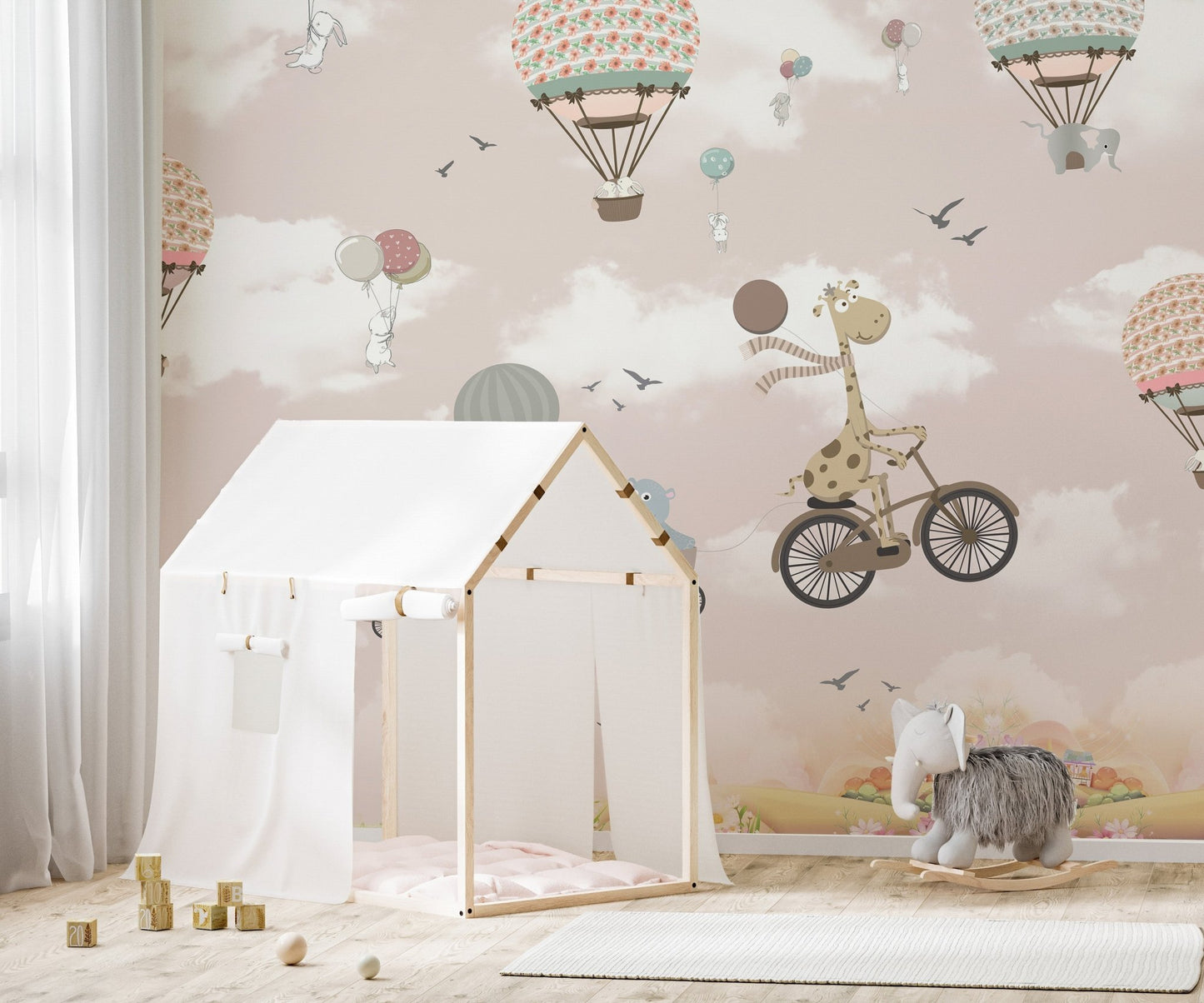 Whimsical animal wall mural featuring a white tent and soft pink cloud patterns.