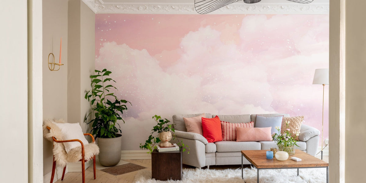 Pink pastel cloud wall mural in a modern living room with a grey sofa.