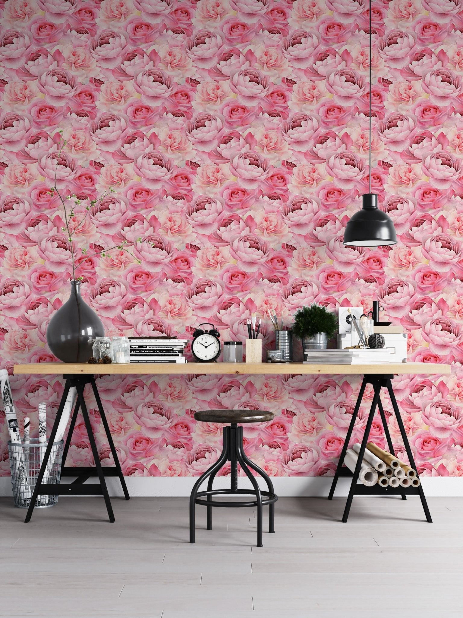 Pink peonies roses wallpaper on office wall with wooden desk and black trestle legs.