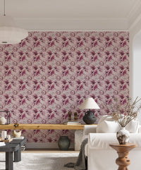 Living area with pink floral wallpaper and a wooden table setup.