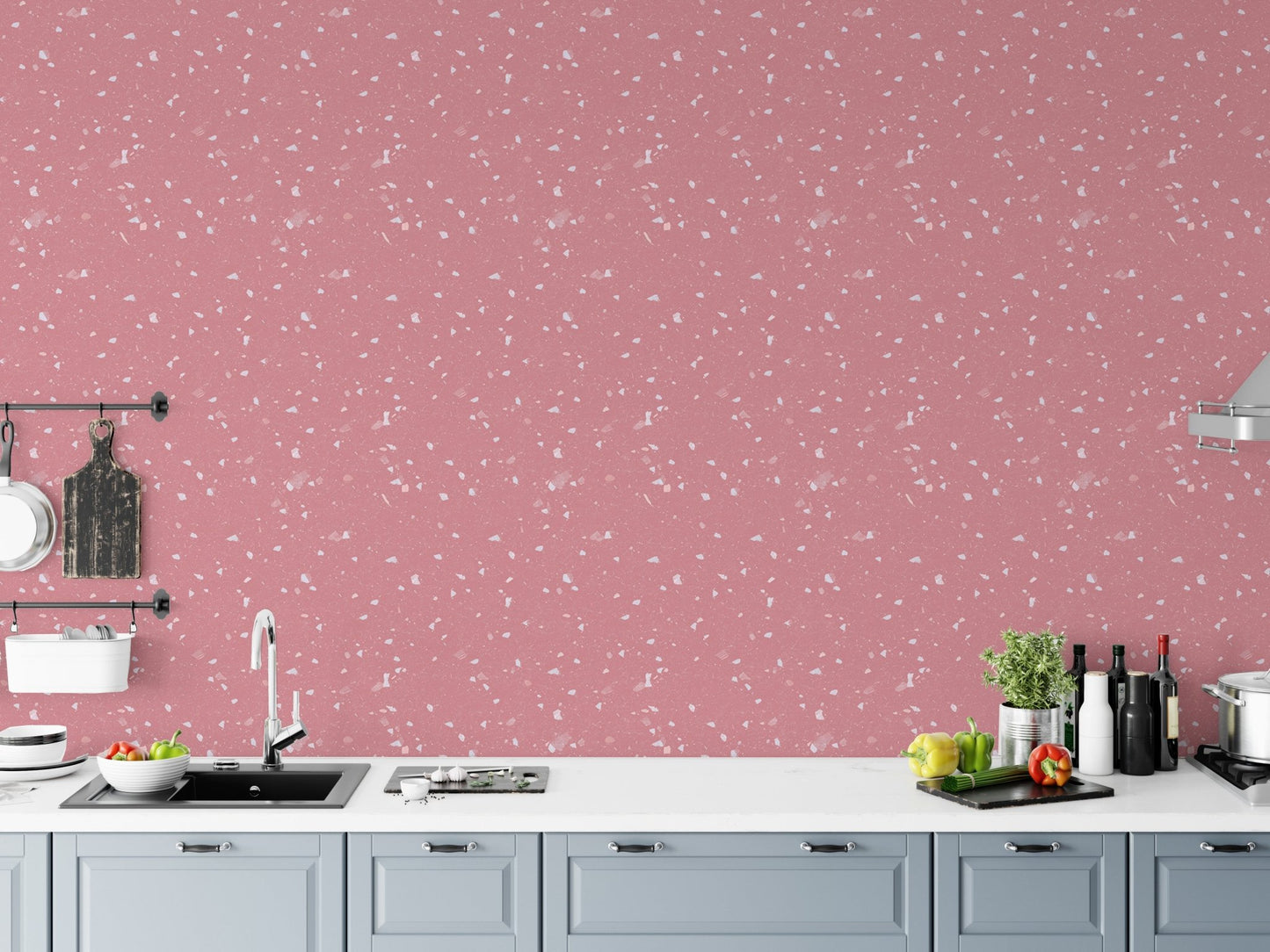 Kitchen backsplash area with pink terrazzo wallpaper and white cabinets.