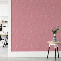 Pink Venetian Quartz Stone Terrazzo Peel and Stick Wallpaper in a hallway with a stool.
