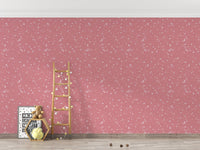 Pink terrazzo wallpaper behind a wooden ladder in a minimalist room.
