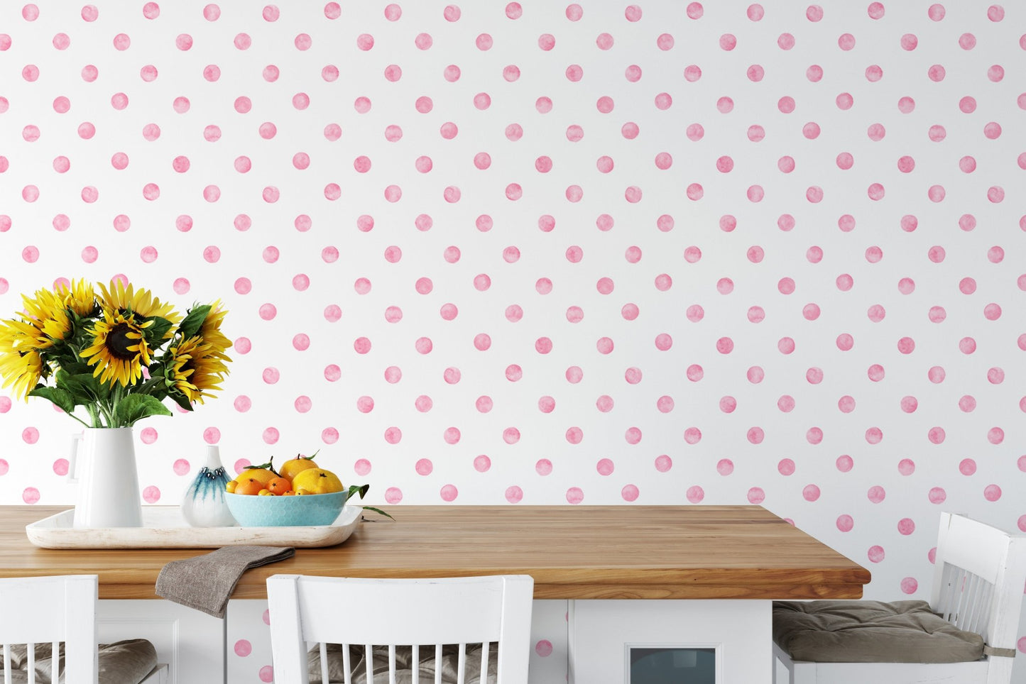 Dining room wallpaper with pink polka dots behind a wooden table and yellow flowers.