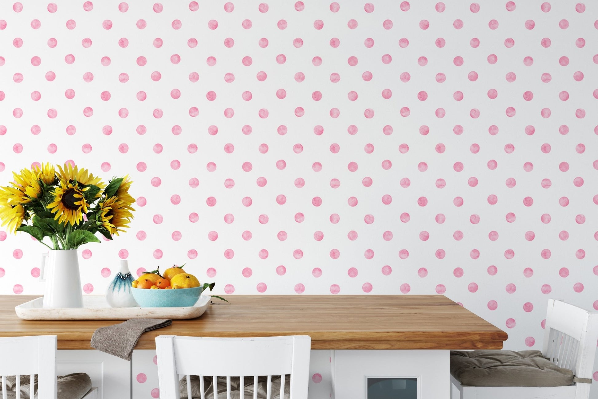 Dining room wallpaper with pink polka dots behind a wooden table and yellow flowers.
