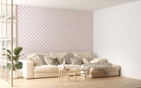 Pink watercolor seamless pattern polka dots wallpaper in a living room with white sofa.