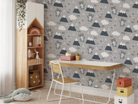 Wallpaper with kitten and cloud motifs in a study space with a desk