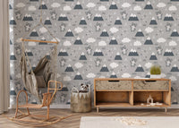 Neutral toned kitty wallpaper behind a wooden desk and chair setup