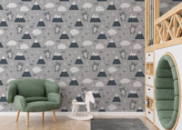 Playful Scandinavian Kitty Wallpaper paired with a green armchair and toys