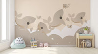Minimal sea life wall mural featuring soft beige whale silhouettes.