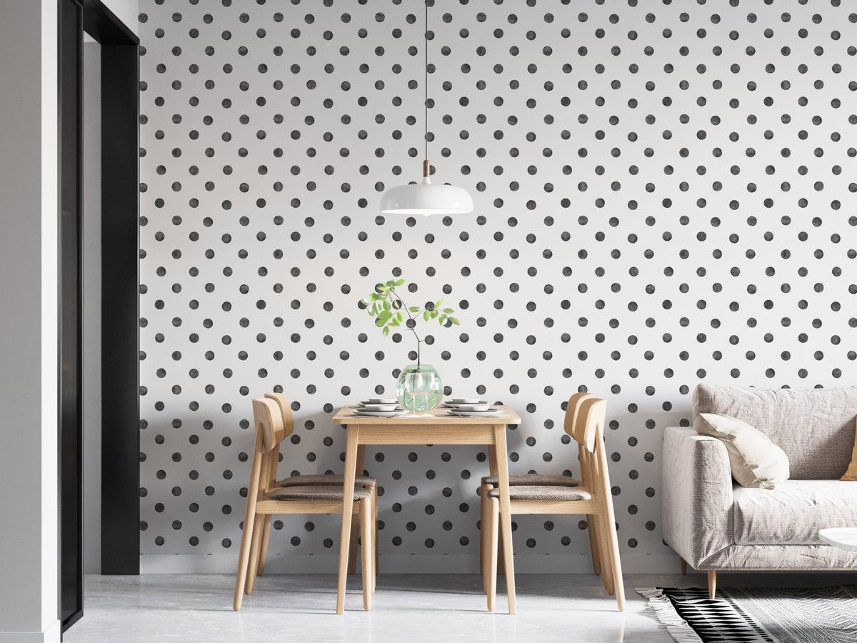 Dining room with black polka dot wallpaper and wooden furniture.
