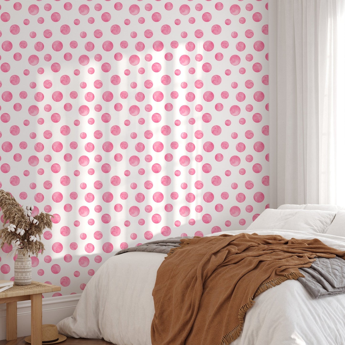 Watercolor abstract circles wallpaper mural in a bright bedroom with a brown throw.