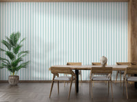 Minimalist dining room featuring wide turquoise stripe wallpaper and wooden furniture.