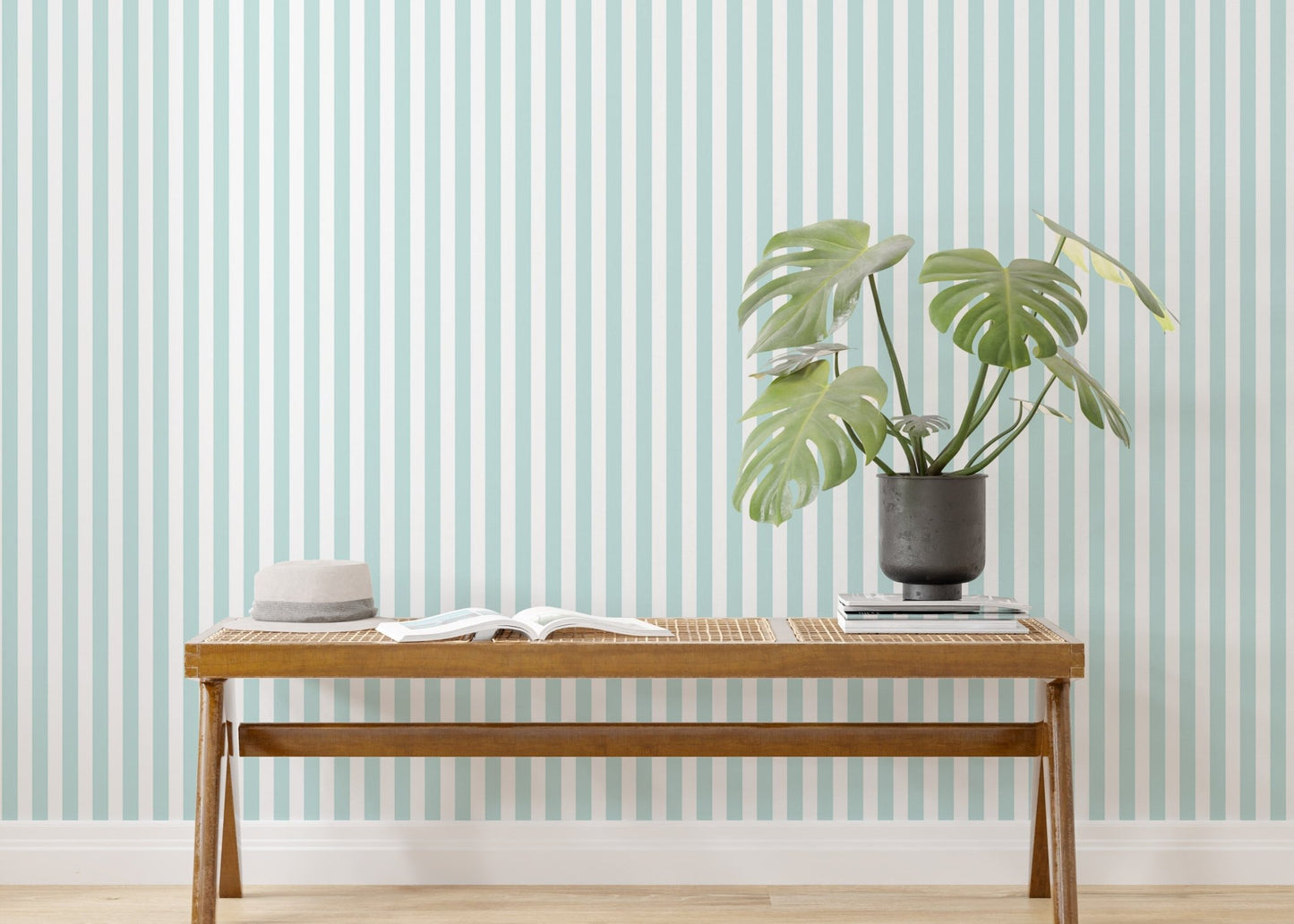 Wooden bench and green plant styled with vertical stripe wallpaper.