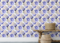 Purple watercolor peonies wallpaper in a bright room with a rustic bench.