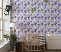 Light background floral wallpaper behind a wooden crib in a nursery room.