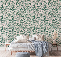 Botanical pattern wallpaper with green leaf patterns in a bright bedroom.