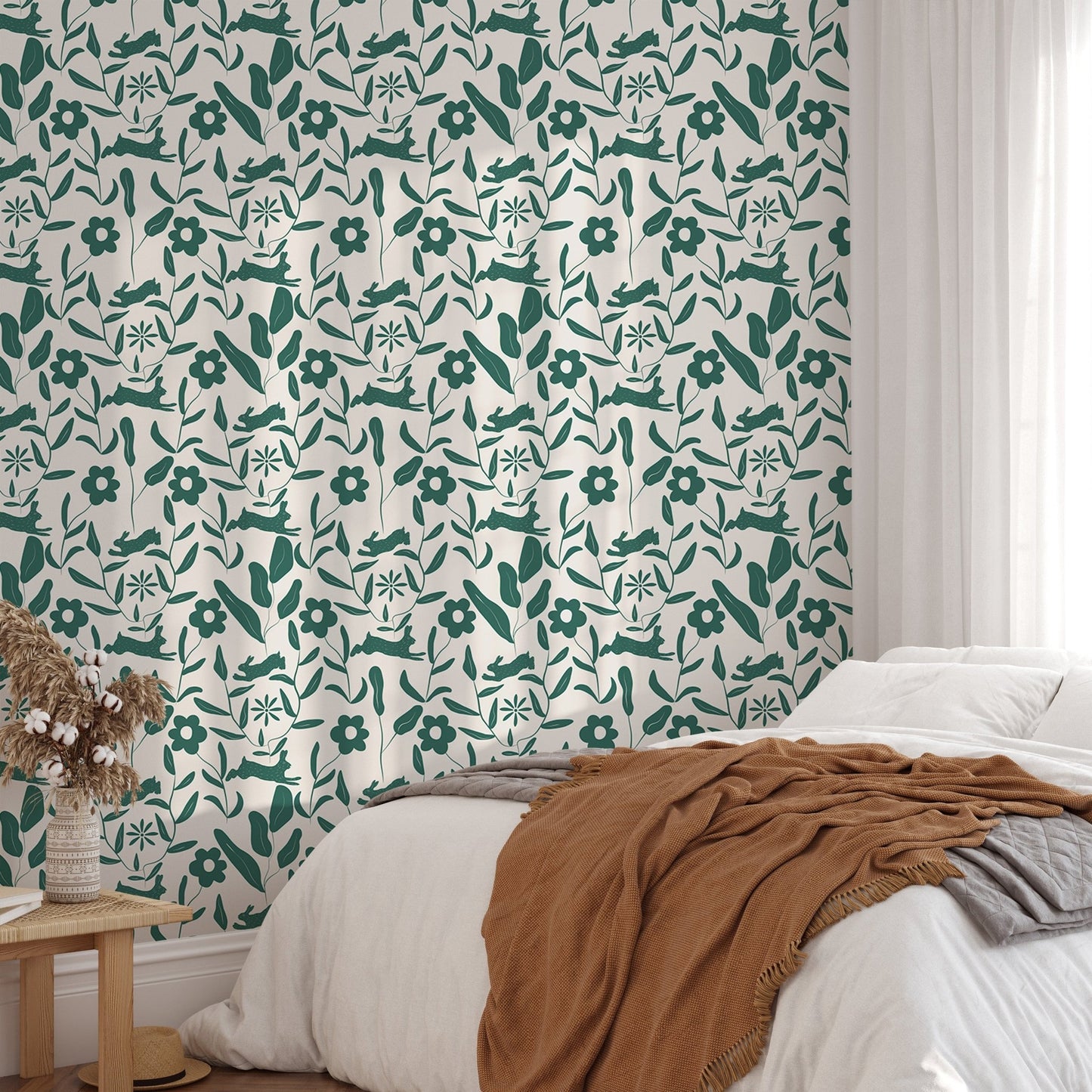 Rabbit Pattern Floral and Leaves Scandi Wallpaper behind a bed with terracotta bedding.