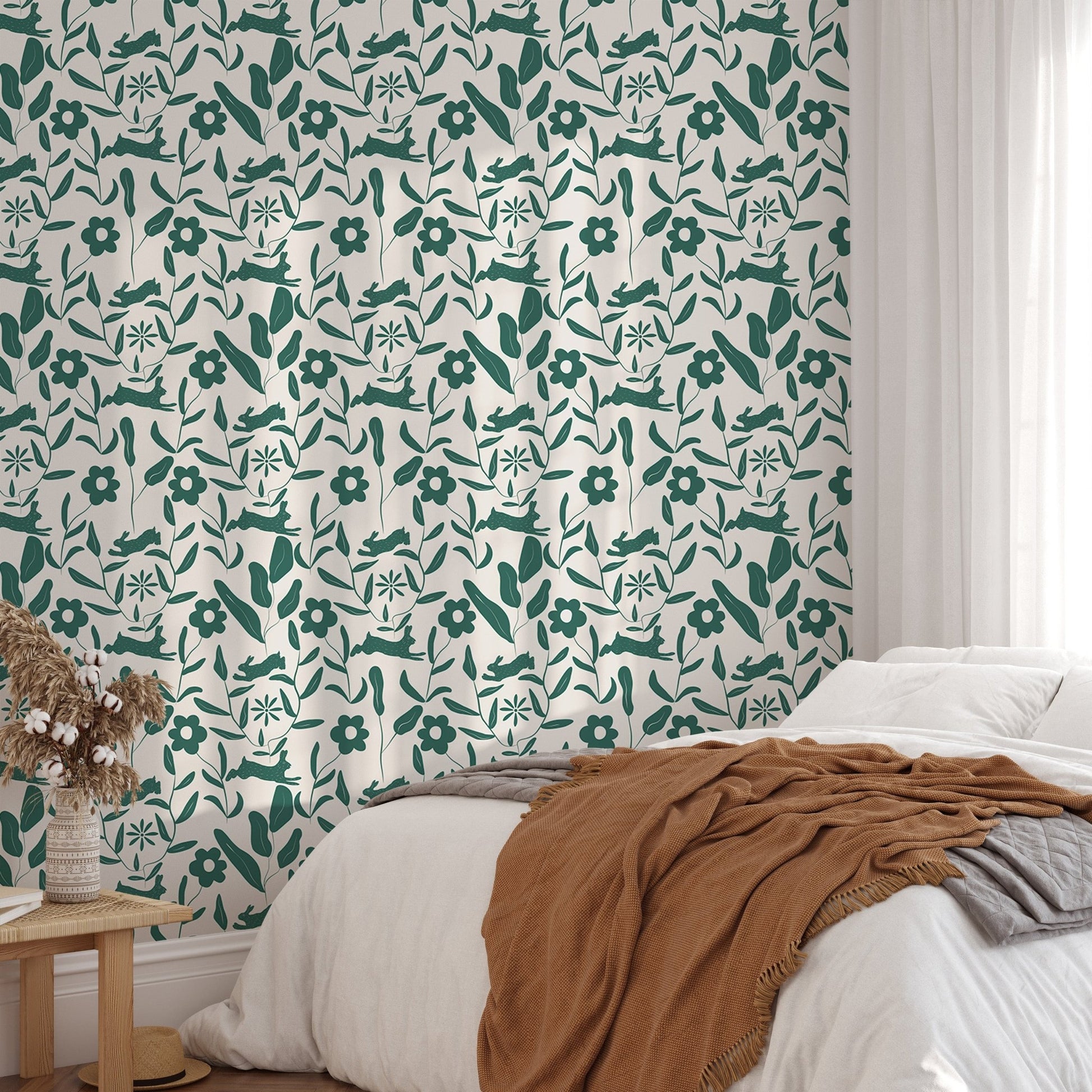 Rabbit Pattern Floral and Leaves Scandi Wallpaper behind a bed with terracotta bedding.