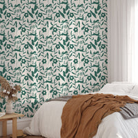 Rabbit Pattern Floral and Leaves Scandi Wallpaper behind a bed with terracotta bedding.