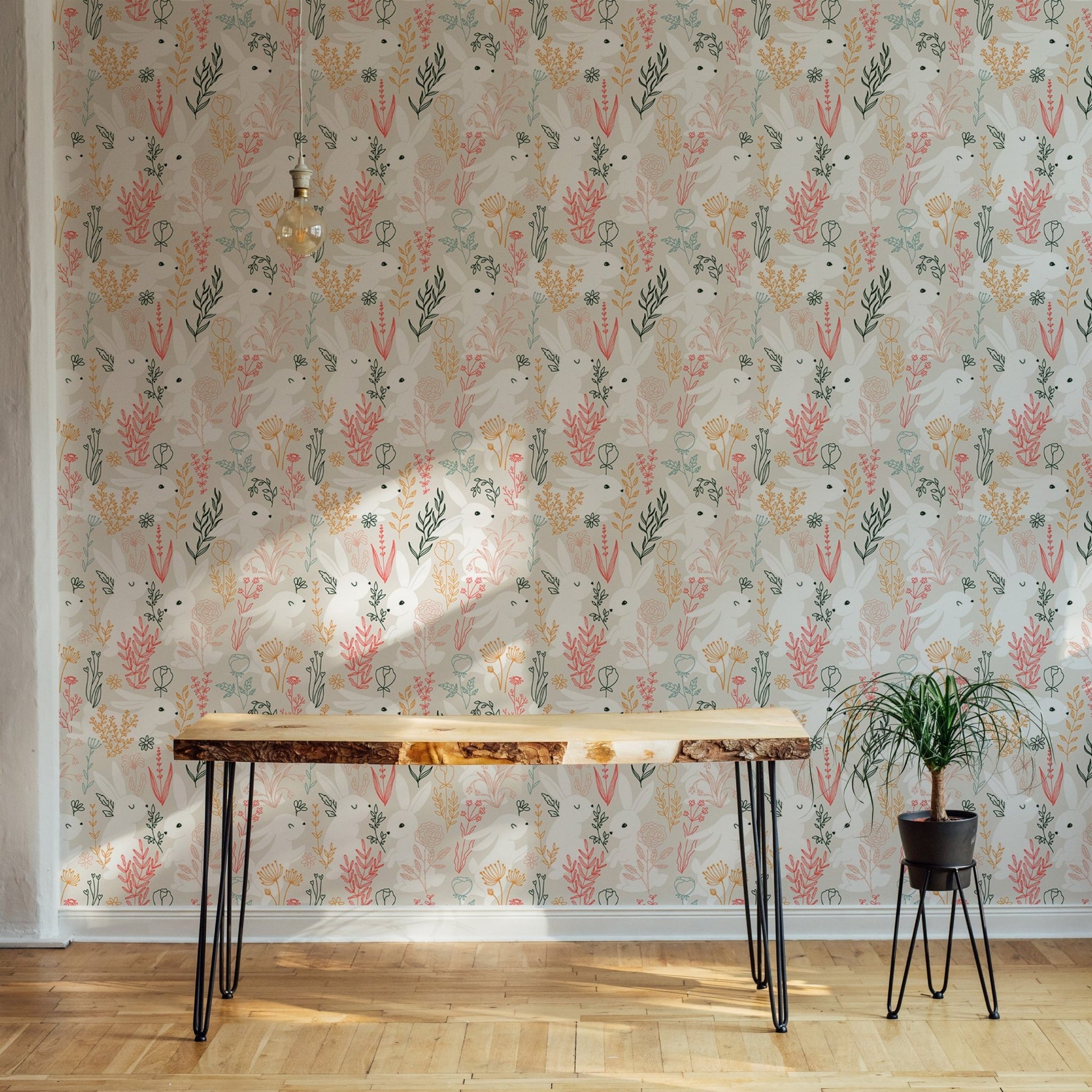 Peel and stick wallpaper featuring white bunnies and botanical print in home office.