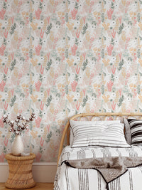 Pastel rabbit and grass wallpaper in a bedroom with wooden side table.